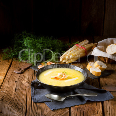 delicious asparagus cream soup with prawns and fresh dill