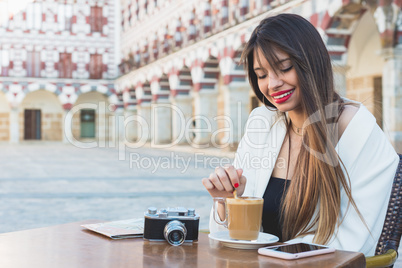 attractive happy woman having a coffee on a street. Lifestyle co