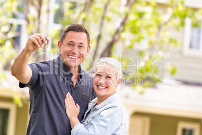 Caucasian Couple in Front of House with Keys