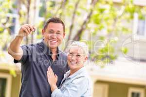 Caucasian Couple in Front of House with Keys