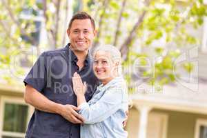 Happy Caucasian Couple in Front of House