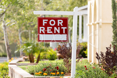 Red For Rent Real Estate Sign in Front House