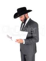 Man in suit and hat reading papers
