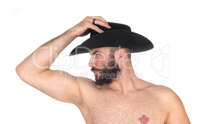 Close up of a shirtless man with a cowboy hat looking away
