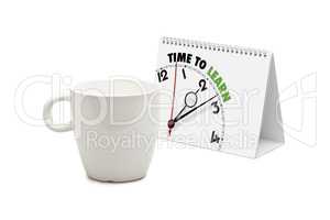 desk calendar with time to learn clock and blank mug