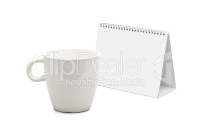 desk calendar and blank mug isolated