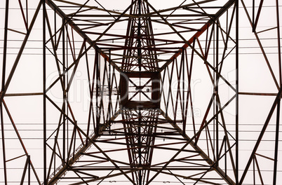 Looking up interior of large electrical tower frame.