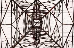 Looking up interior of large electrical tower frame.