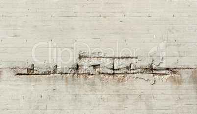 Dirty cement wall with large horizontal cracks.