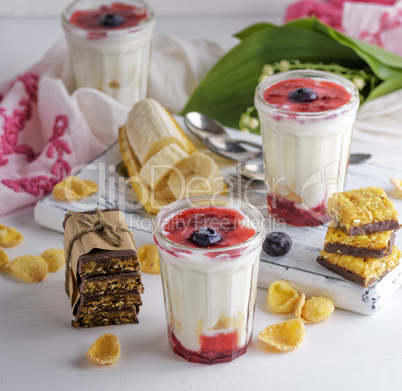yogurt in transparent glass with syrup and banana