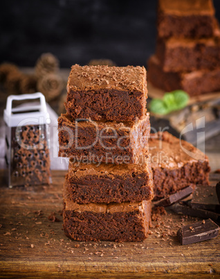 a stack of square pieces of baked brownie