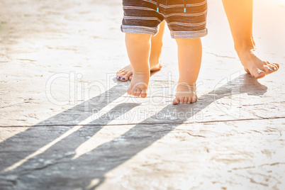 Mother and Baby Feet Taking Steps Outdoors