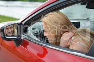 Just checking makeup, young girl in a car