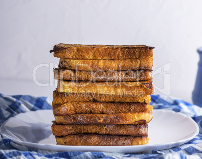 fried French toast on a ceramic white plate