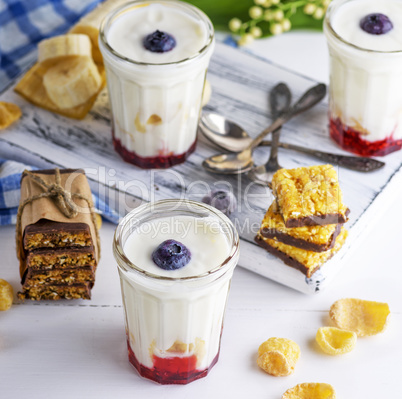 yogurt in transparent glass with syrup and banana