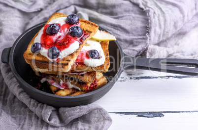 French toast with berries, syrup and sour cream