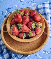 fresh ripe red strawberry in a brown wooden plate