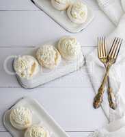 baked round meringue with cream on white iron trays