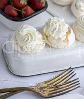 baked meringue with cream and two forks