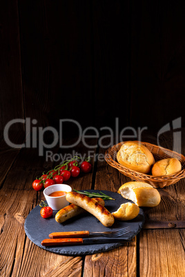 rustic bratwurst with ketchup and fresh rolls