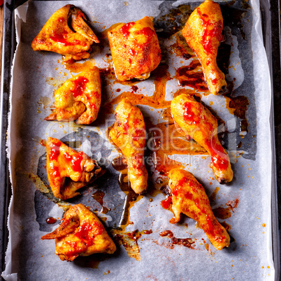 Rustic backed chicken wings,legs on baking tray