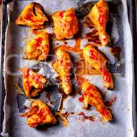 Rustic backed chicken wings,legs on baking tray