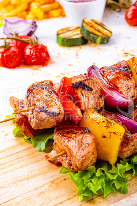 tasty and colorful meat skewers with peppers and onions