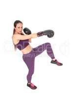 Slim woman in workout outfit boxing
