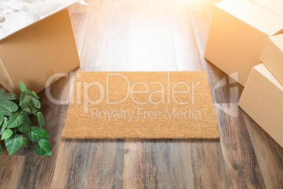 Blank Welcome Mat, Moving Boxes and Plant on Hard Wood Floors