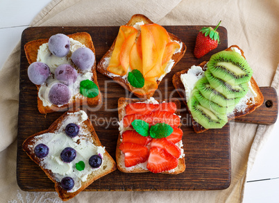 French toasts with soft cheese, strawberries, kiwi, walnuts