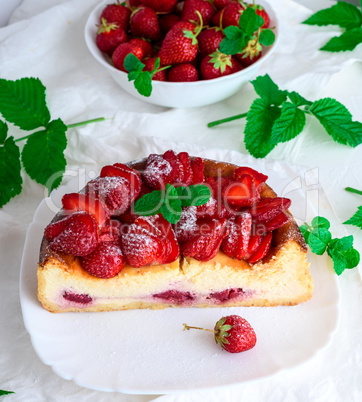 half cheesecake made of cottage cheese and fresh strawberries