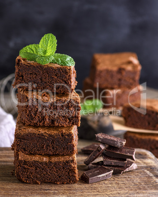 square pieces of baked brownie lie in a pile