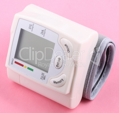 Automatic Wrist Digital blood pressure monitor on pink backgroun