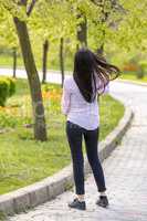 Teenager brunette girl walking in park