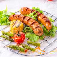grilled tasty krakauer sausage with boiled corn and green salad
