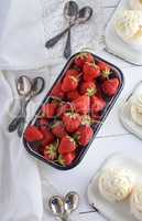 fresh ripe strawberry in a white iron plate