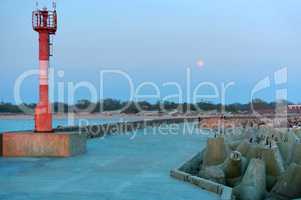 promenade in the moonlight, pier with the coast fortifications, lighthouse on sea pier