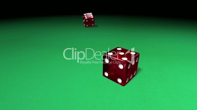 Red dice rolling on green casino table