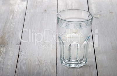 Glass of water on white wooden table