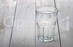 Glass of water on white wooden table