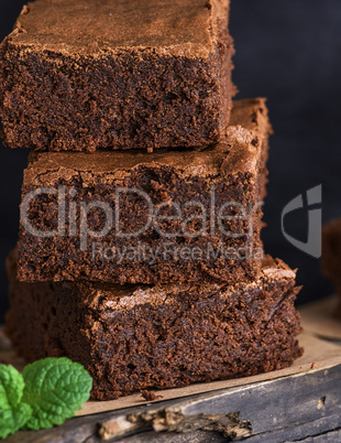 square pieces of baked brownie lie in a pile