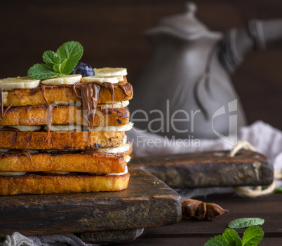 square fried bread slices with chocolate and banana