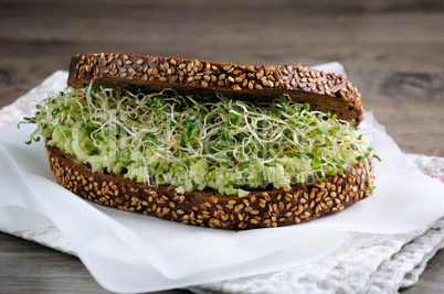 Sandwich with avocado and alfalfa sprouts