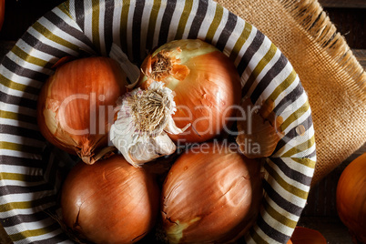 Still life of fresh onions and garlic head.