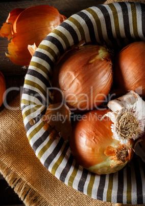 Still life of fresh onions and garlic head.