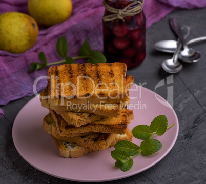 fried French toast on a ceramic pink plate