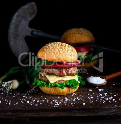 homemade burger with lettuce, cheese, onion and tomato