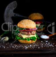 homemade burger with lettuce, cheese, onion and tomato