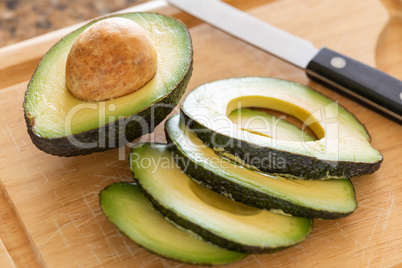 Fresh Cut Avocado on Wooden Cutting Board