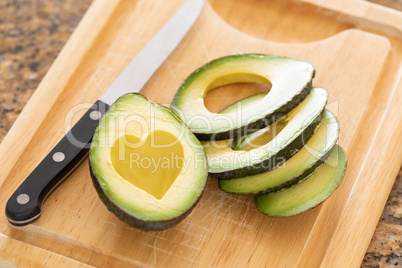 Fresh Cut Avocado With Heart Shaped Pit Area On Wooden Cutting B
